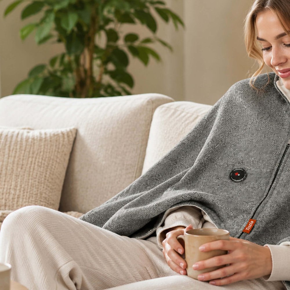 Tozia heated shawl worn on a sofa